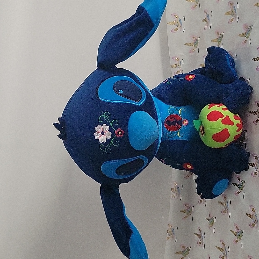 Blue Plush Stuffed Animal with Large Ears and Colorful Patches
